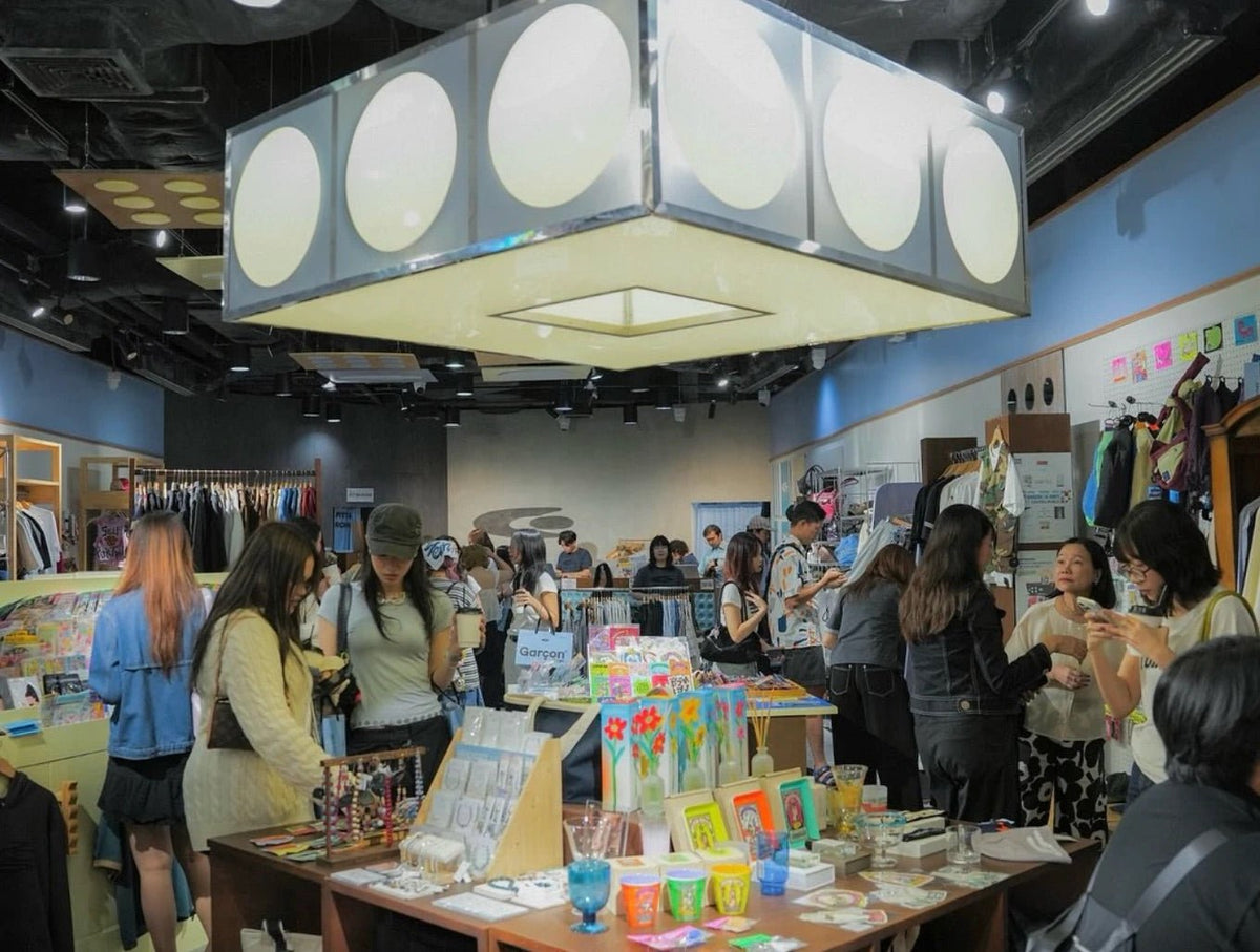 CentralWorld store busy with shoppers under a large lantern-style light fixture