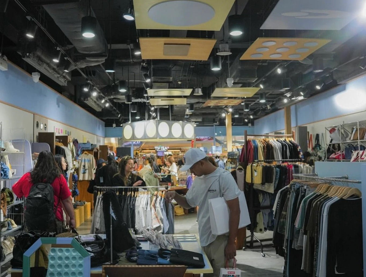 CentralWorld interior with suspended wooden ceiling panels and clothing racks