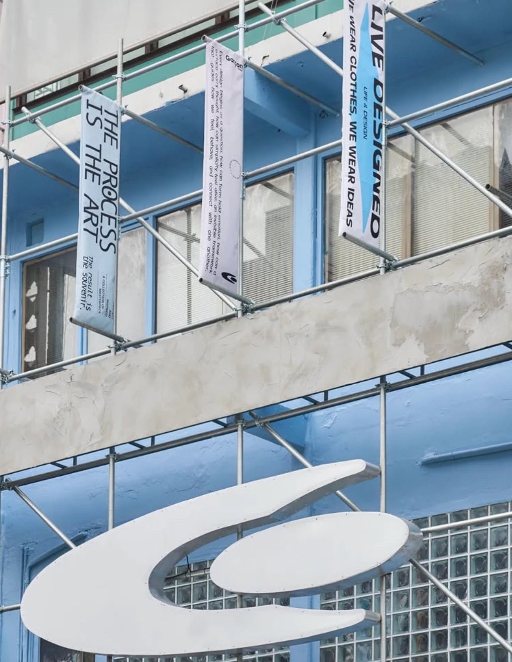 Close-up of the oversized logo sign and hanging banners on the Siam Square building