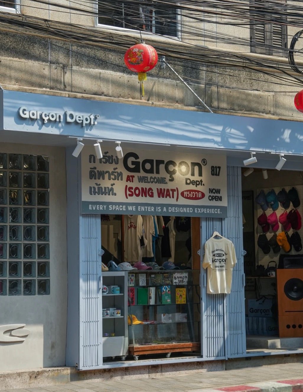 Garçon Dept. Songwat storefront with a light blue facade and a red lantern